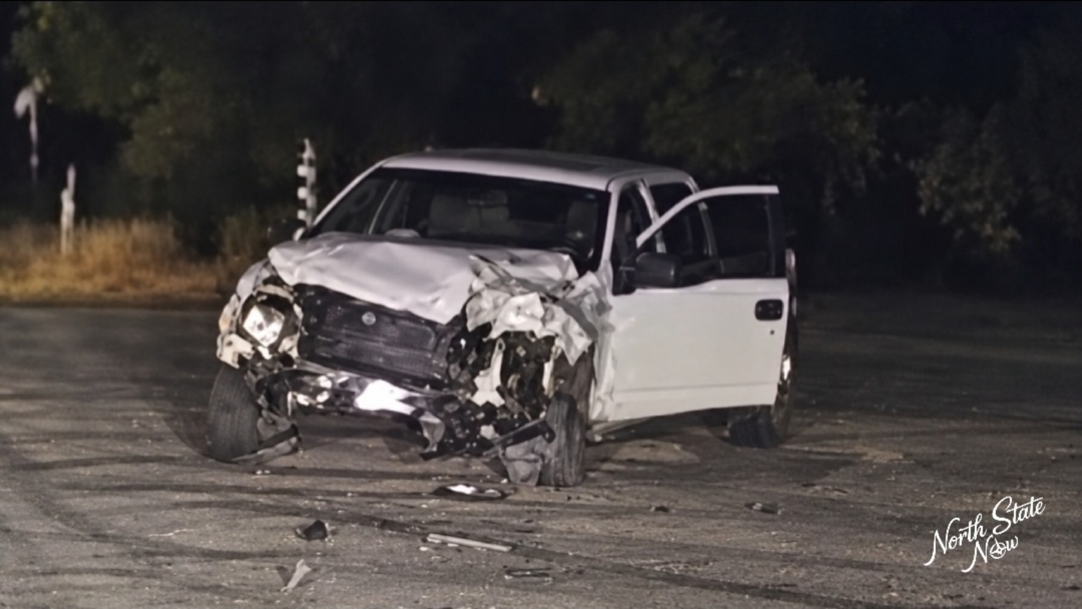 A damaged white pickup at the scene of the Airport Road crash in Redding.