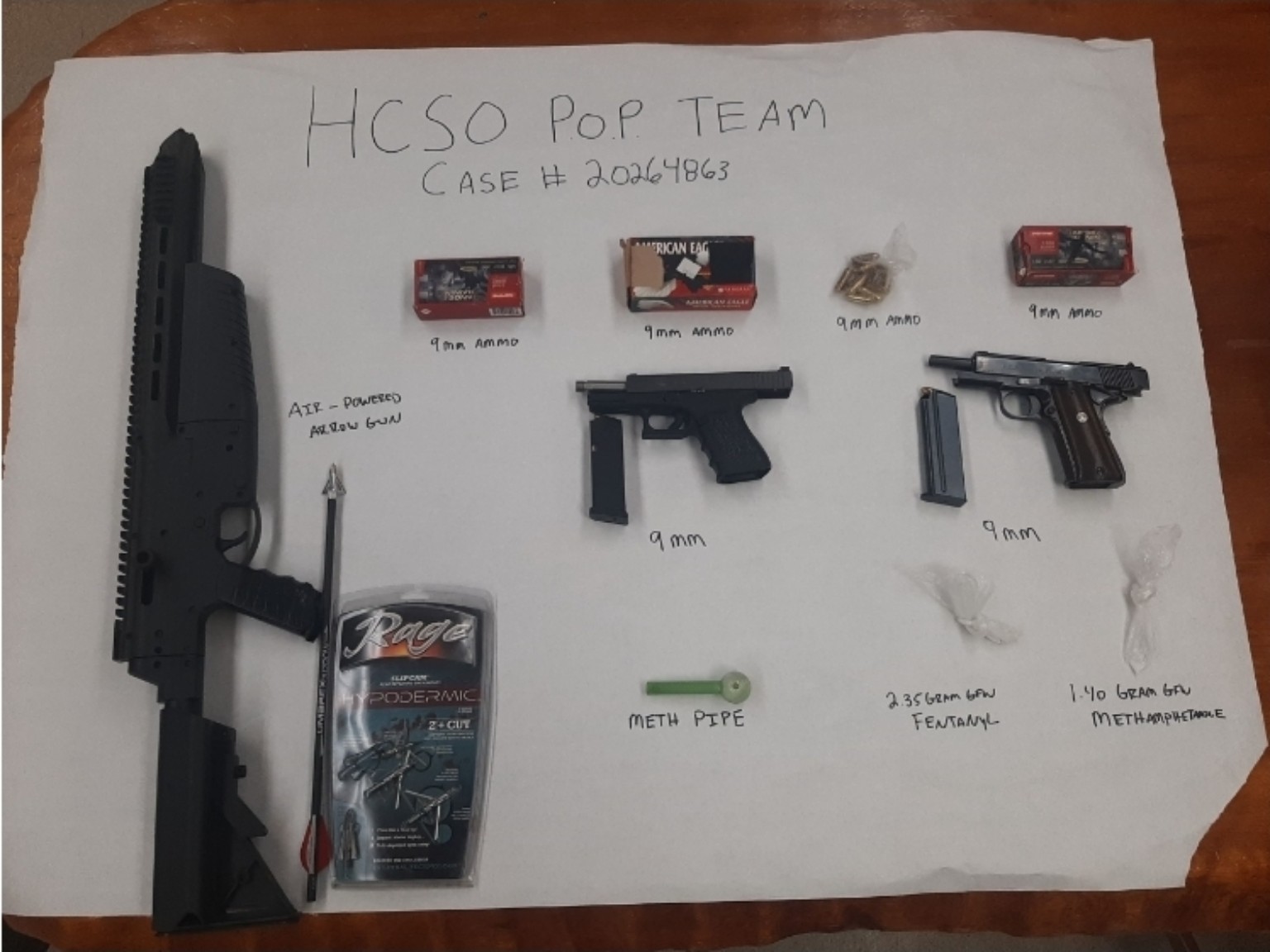 Evidence displayed by the Humboldt County Sheriff’s Office, including two handguns, ammunition, an air powered arrow gun and suspected narcotics.