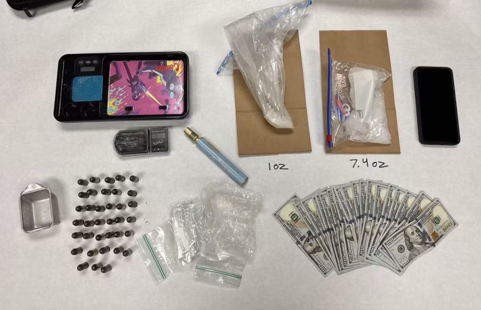 Methamphetamine, ammunition, cash and other items displayed by investigators. Photo courtesy of the Redding Police Department.